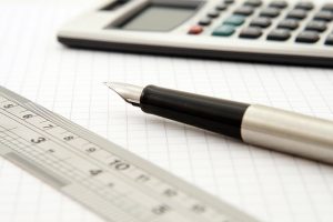 Pen, paper and a calculator to help someone calculate your moving costs.