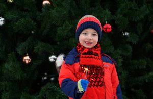 A child in front of a Christmas tree
