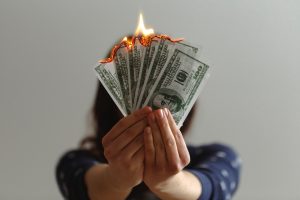 a fan of fake dollar bills on fire